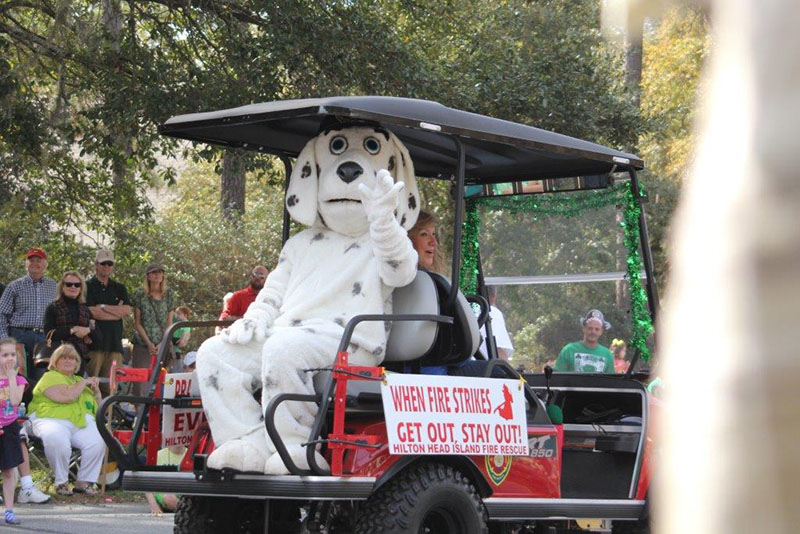 Fire Rescue Dog Mascot on golf cart in parade