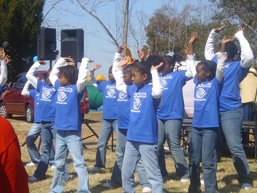 Children in Boys and Girls Club T-shirts performing