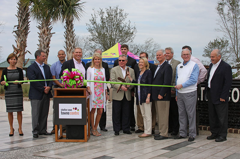 Ribbon cutting ceremony in front of park sign