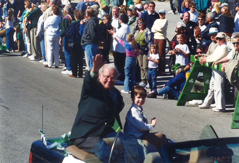 Charles Fraser waves from car in parade